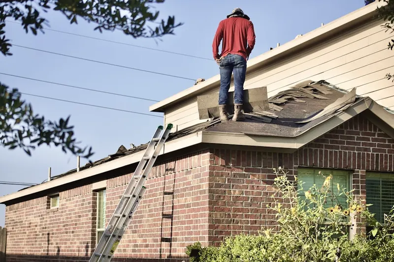 Professional roofer working on a residential roof in Streamwood